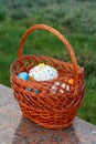 Easter cake and colorful Easter eggs in wicker basket Royalty Free Stock Photo