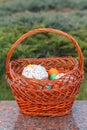 Easter cake and colorful Easter eggs in wicker basket Royalty Free Stock Photo