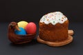 Easter cake and colorful Easter eggs in wicker basket Royalty Free Stock Photo