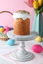 Easter cake, colorful eggs and tulips on white wooden table Royalty Free Stock Photo