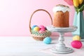 Easter cake, colorful eggs and tulips on white wooden table, space for text Royalty Free Stock Photo