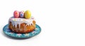 Easter cake with icing and colorful Easter eggs on blue decorative plate Royalty Free Stock Photo