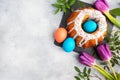 Easter cake in icing sugar painted eggs and tulips on the table. Top view copy space Royalty Free Stock Photo