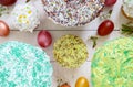 Easter bread kulich with glaze, colorful sugar sprinkles. Colored painted eggs. Royalty Free Stock Photo