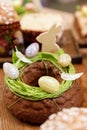 Easter cake orthodox sweet bread kulich and colorful chocolate eggs on festive table Royalty Free Stock Photo