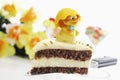 Easter cake, piece of marzipan cake with pistachio and chick figurine
