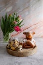 Easter cake in the shape of a lamb with Easter eggs and spring flowers on the table Royalty Free Stock Photo