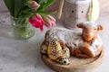 Easter cake in the shape of a lamb with Easter eggs and spring flowers on the table Royalty Free Stock Photo