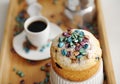 Easter cake sprinkled colored pearl coffee beans close up. Espresso maker moka pot and cup of coffee on the background Royalty Free Stock Photo