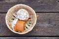 Easter cake in a straw basket on a table outdoors close up, Easter holiday Royalty Free Stock Photo