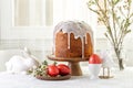 Easter cake or sweet bread decorated with white icing, red coloured Paschal eggs