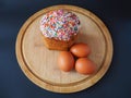 An easter cake with three eggs on the wooden board Royalty Free Stock Photo