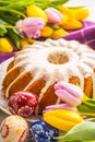 Easter Cake. Traditional ring marble cake withe easter decotation. Easter eggs and spring tulips. Royalty Free Stock Photo