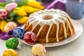 Easter Cake. Traditional ring marble cake withe easter decotation. Easter eggs and spring tulips. Royalty Free Stock Photo