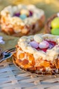 Nuts and oval sweet sweets in the form of eggs. Beautiful blurred background. Easter cake on a wooden table and bronze paper. Royalty Free Stock Photo