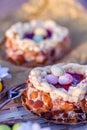 Easter Sponge cake nest. Nuts and oval sweet sweets in the form of eggs. Beautiful blurred background. Decoration for the holiday Royalty Free Stock Photo