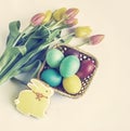 Easter cake, yellow and red tylips, bunny-gingerbread on white. Easter holiday background