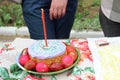 Easter cakes with a candle and colorful Easter eggs. Orthodox Easter, preparation for consecration with Holy water. without faces Royalty Free Stock Photo