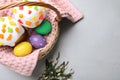 Easter cakes and painted eggs on light grey table, flat lay Royalty Free Stock Photo