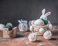 Easter card, a basket with a figurine of a rabbit with eggs, straw decorative balls