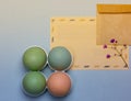 Easter card, brown envelope with space for text. Four pastel colored Easter eggs