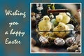 Easter card with chickens and eggs in wire basket and wishes on left side Royalty Free Stock Photo