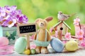 easter card with clay rabbit and decorations on spring background Royalty Free Stock Photo