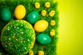 Easter celebrating cake on green grass with yellow toy chickens