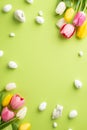 Top view vertical photo of quail eggs fresh flowers bunches of colorful tulips and ceramic bunnies