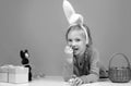 Easter child. Funny girl wearing bunny ears and having fun with Easter eggs. Cute little child girl wearing bunny ears Royalty Free Stock Photo