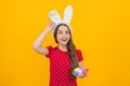 Easter child holidays concept. Happy smiling little teenage girl with bunny ears holding painted easter eggs. Excited Royalty Free Stock Photo