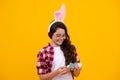 Easter child holidays concept. Happy smiling little teenage girl with bunny ears holding painted easter eggs. Happy Royalty Free Stock Photo