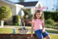 Easter children. Child in bunny ears hold Easter egg. Boy hunting easter egg.