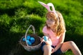 Easter children. Happy Easter. Kids in bunny ears with Easter egg in basket. Boy play in hunting eggs.