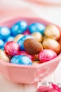 Easter chocolate eggs wrapped in aluminium foil in bowl on white table Royalty Free Stock Photo