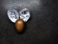 Easter chocolate kinder egg with a foil on a black table