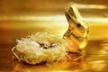 Easter chocolate rabbit and eggs on gold background Royalty Free Stock Photo