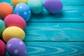 Easter colored eggs on blue wooden background