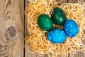 Easter colored eggs, straw, flowers