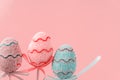 Easter colorful decorated eggs stand on a sticks on pink background. Minimal easter concept. Happy Easter card with copy space for Royalty Free Stock Photo