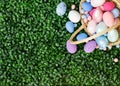 Easter colorful eggs in a basket on the green grass. Beautiful Easter composition. Copy space. View from above Royalty Free Stock Photo