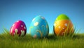 Easter colorful eggs in fresh green grass over blue sky. Royalty Free Stock Photo