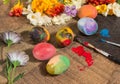 Easter colorful eggs with spring flowers and two painter's brushes. Royalty Free Stock Photo