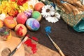 Easter colorful eggs with spring flowers and two painter's brushes. Royalty Free Stock Photo