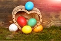 Easter colorful eggs in wooden heart box Royalty Free Stock Photo