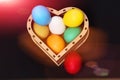 Easter colorful eggs in wooden heart box isolated on black Royalty Free Stock Photo