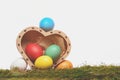 Easter colorful eggs in wooden heart box isolated on white Royalty Free Stock Photo