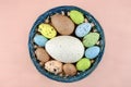 Easter colorful quail eggs on a pale pink background. Royalty Free Stock Photo