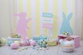 Easter! Colorful Easter room interior. Many colorful Easter eggs with bunnies and baskets of flowers! Children`s playroom. Spring