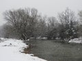 Snow falling over creek as Nor-Easter approaches Royalty Free Stock Photo